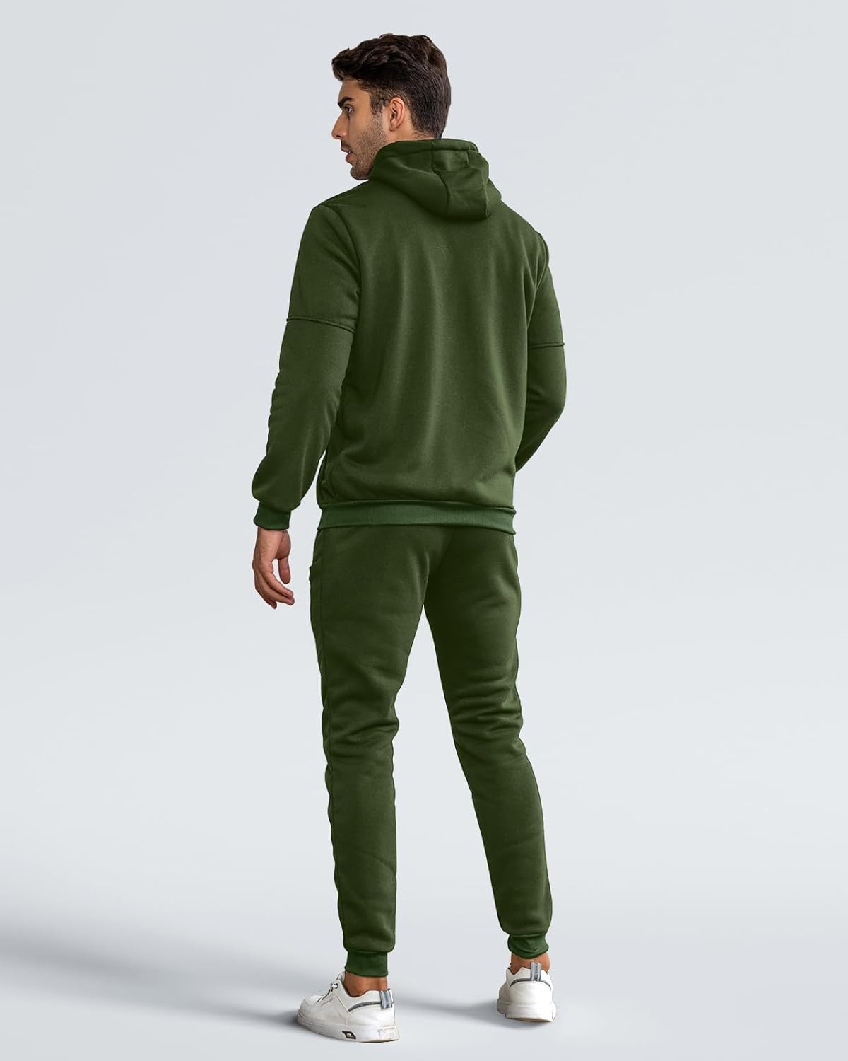 Back view of the green hooded tracksuit on a model, showing the plain back and ribbed cuffs 16