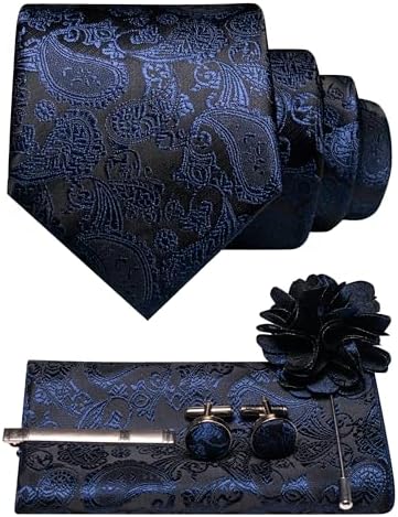Navy blue paisley tie set flat lay with rolled tie, pocket square, tie clip, cufflinks and flower lapel pin. 23