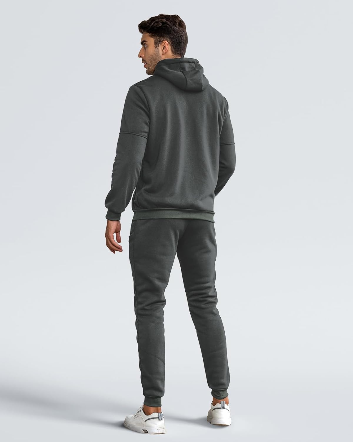 Back view of the grey hooded tracksuit on a model, showing the hood, ribbed hem and cuffs 9