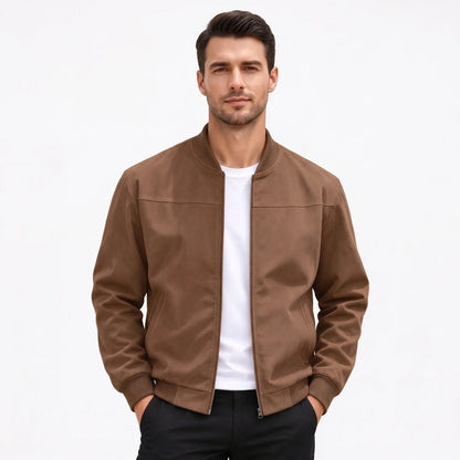 Studio shot of a model in the brown jacket, zip open, hands in trouser pockets 52