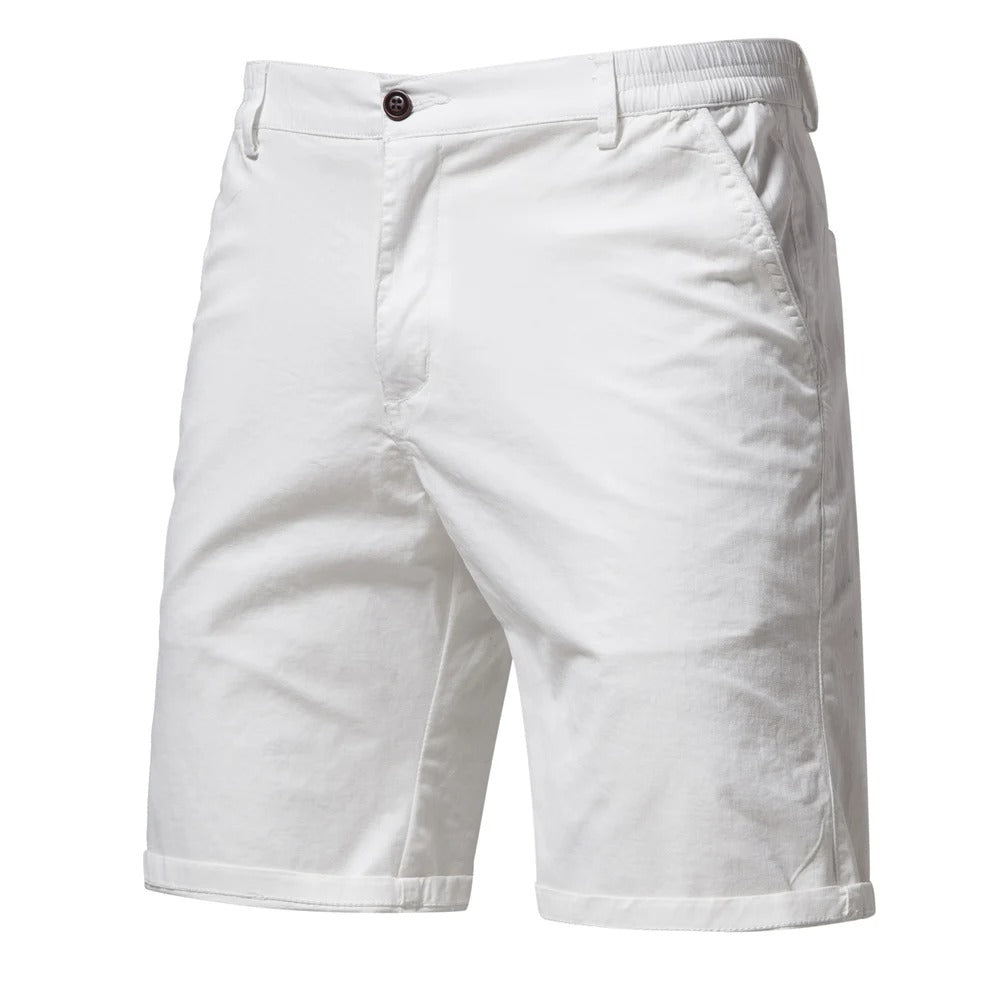 Front view of the shorts in white, with a dark button, side pockets, belt loops and cuffed hems. 9