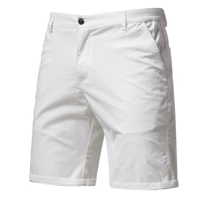 Front view of the shorts in white, with a dark button, side pockets, belt loops and cuffed hems. 9