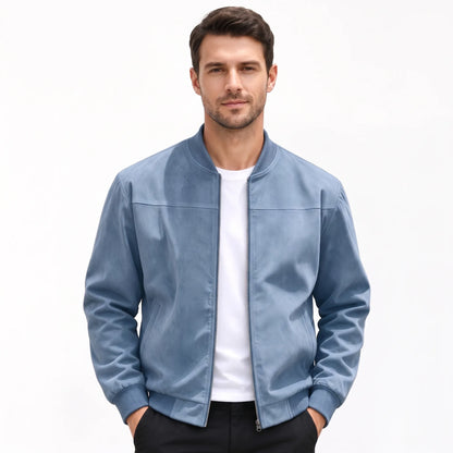Studio shot of a model in the dusty blue jacket, zip open, hands in trouser pockets 54
