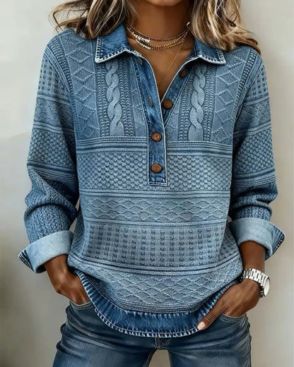 Model wearing the all-blue version with a denim-look collar, cable and diamond textured stripes, wooden buttons and turned-back cuffs, hands in jeans pockets. 1