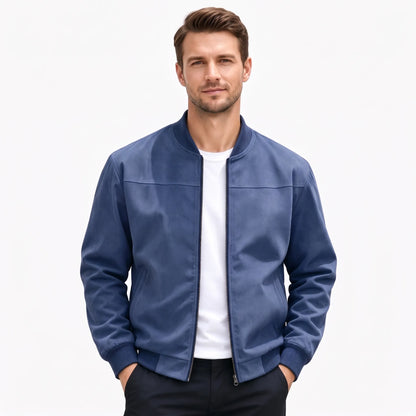 Studio shot of a model in the navy blue jacket, zip open, hands in trouser pockets 55