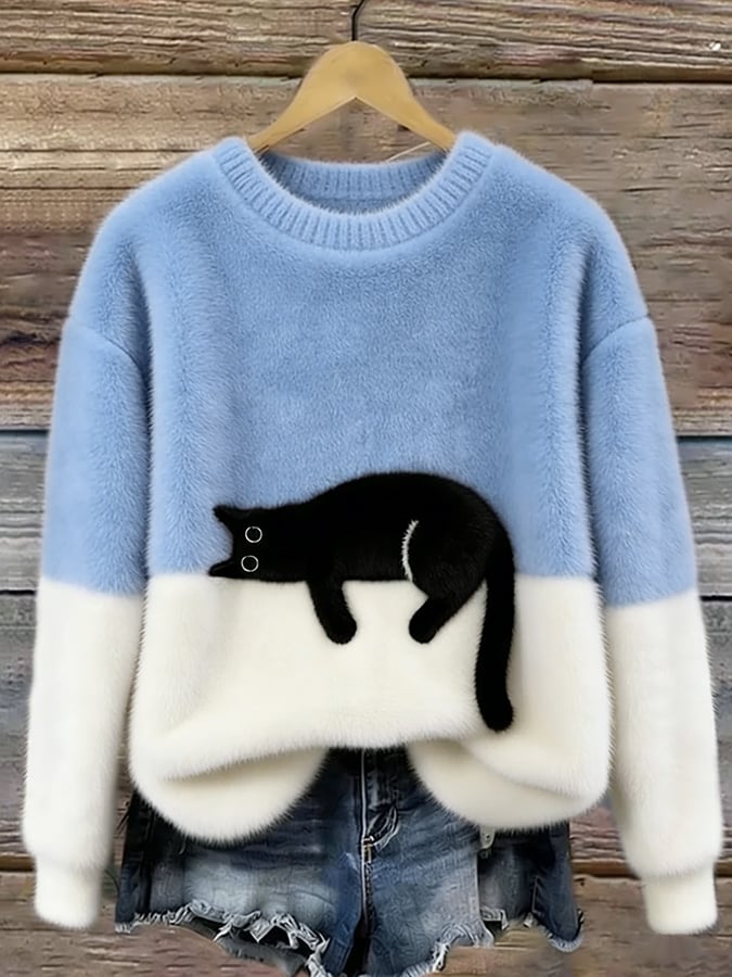 Fluffy jumper with pale blue upper half, white lower half and black cat patch, on a hanger 1