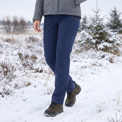 Navy softshell trousers worn with hiking boots and a grey jacket on a snowy heath 1