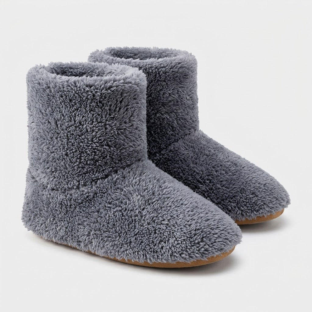 Pair of grey plush ankle-high slippers on a plain white background, shown from the front and side with tan soles. 6