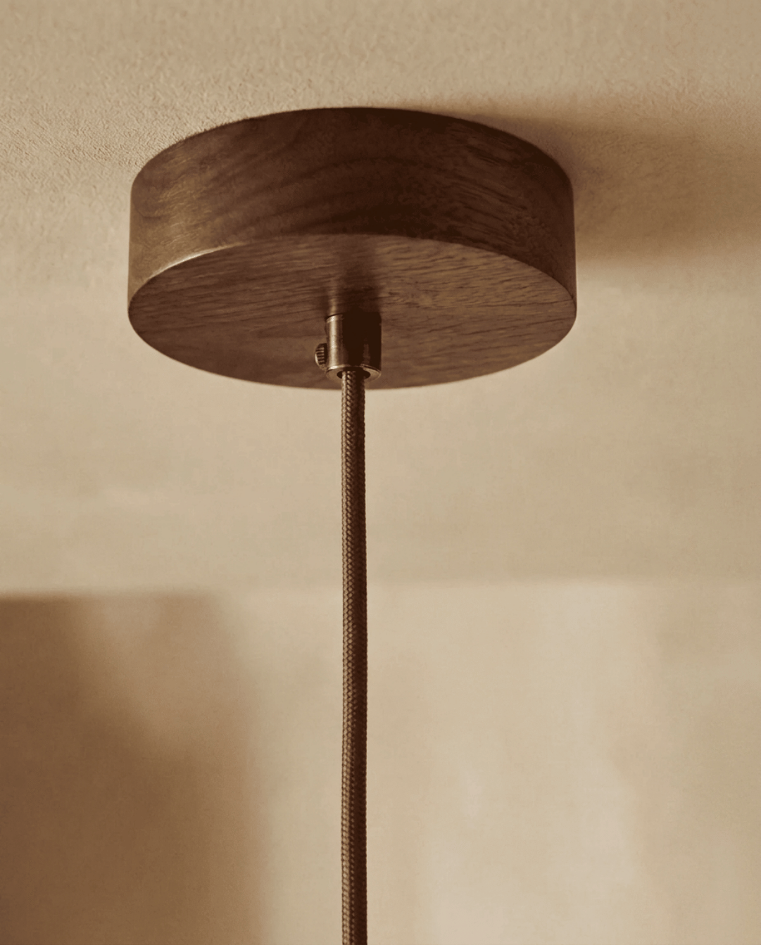 Detail of the round wooden ceiling canopy with the braided fabric cord and metal cord grip 5