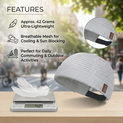 Pale grey mesh cap on a table beside a feather on a scale, with a close-up of the strap 5