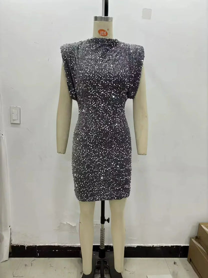 Grey sequinned mini dress with padded shoulders displayed on a mannequin against a plain wall 5
