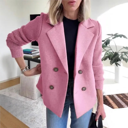 Pink double-breasted jacket with ribbed knit sleeves, styled with black top and jeans in a lounge 5