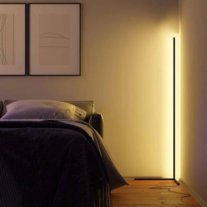 Lamp in a bedroom corner giving off a soft yellow glow, with a trailing cable 4