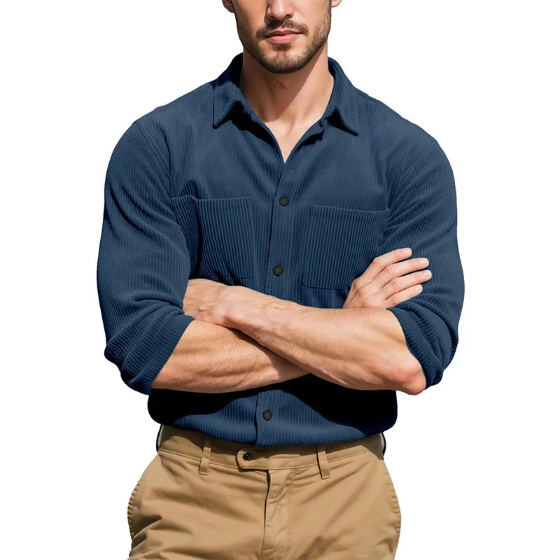 Model with arms crossed wearing the navy blue ribbed shirt with sleeves rolled, over khaki trousers 5