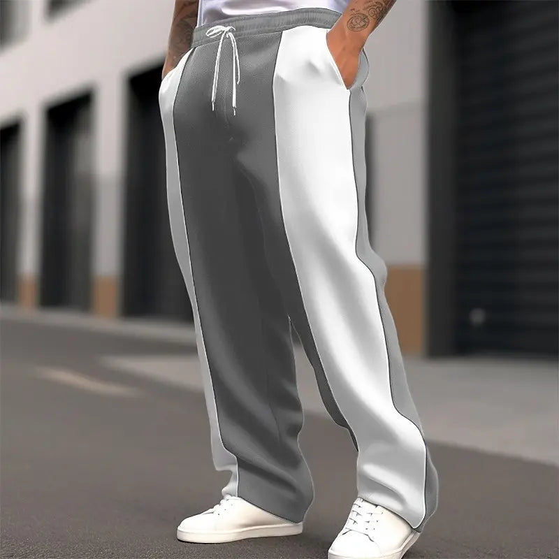 Street shot, lower body, of grey and white colour-block sweatpants with white drawstring 5
