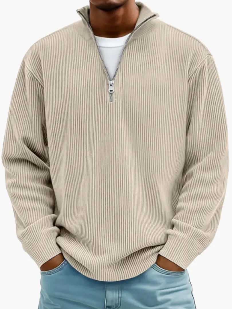 Man wearing the ribbed quarter-zip jumper in beige over a white tee, hands in the pockets of light blue jeans. 4