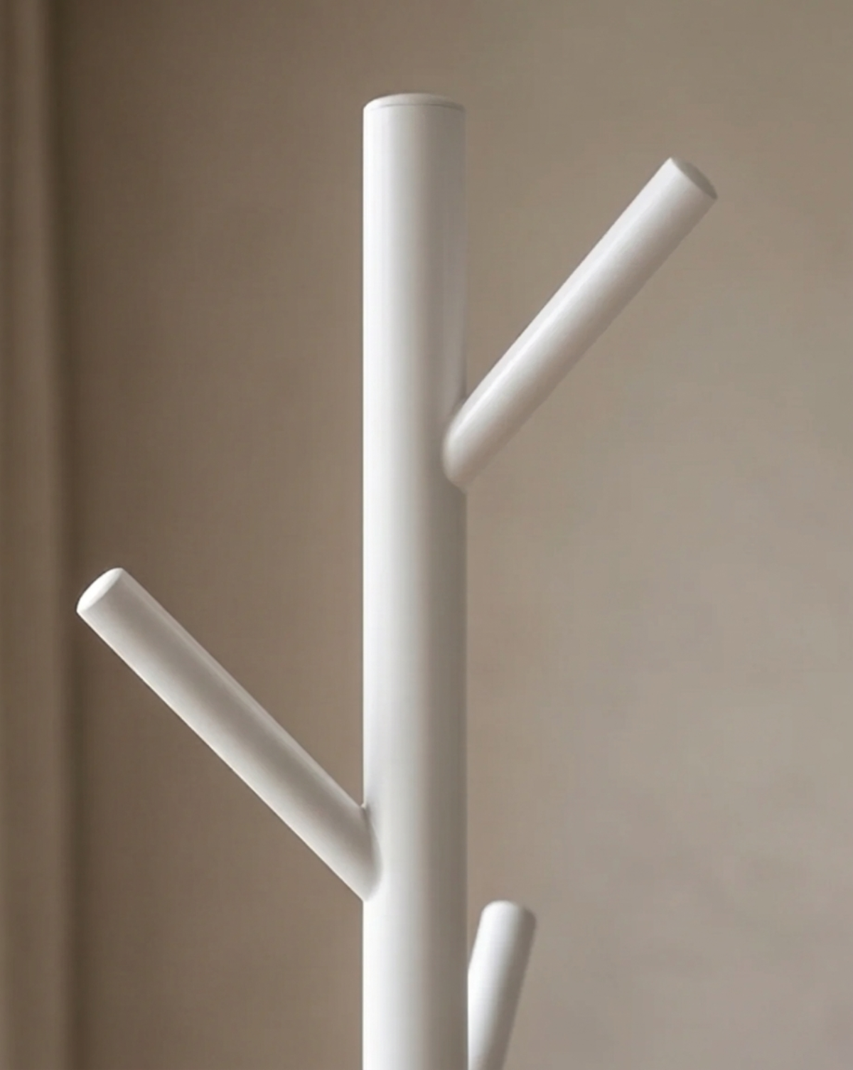 Close-up of the top of the white pole, showing the rounded cap and two smooth angled hooks. 5