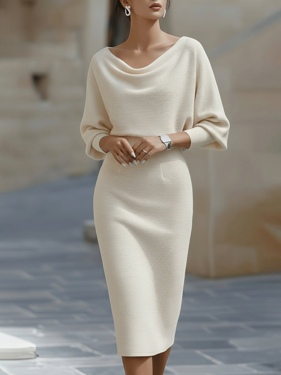 Model wearing the midi dress in cream, front view, with draped boat neckline, wide sleeves and a slim pencil skirt. 3