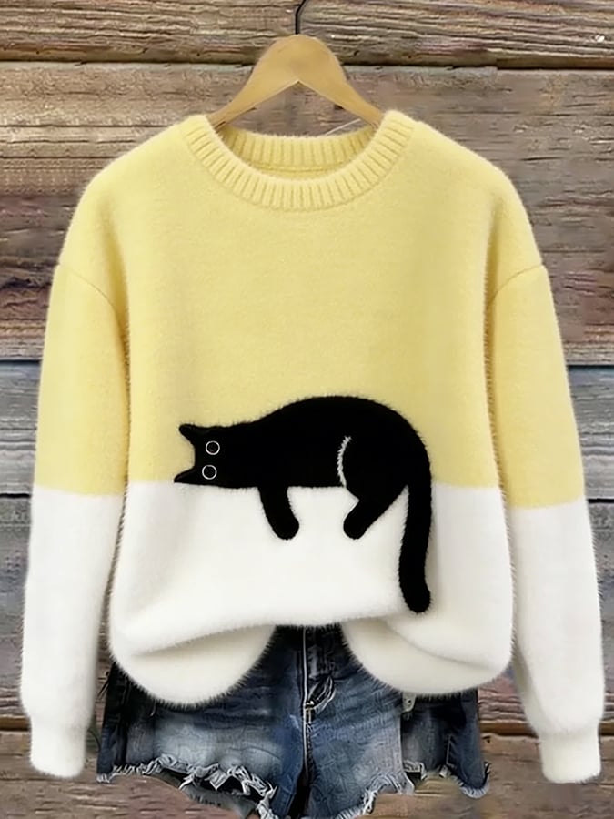 Fluffy jumper with pale yellow upper half, white lower half and black cat patch, on a hanger 7