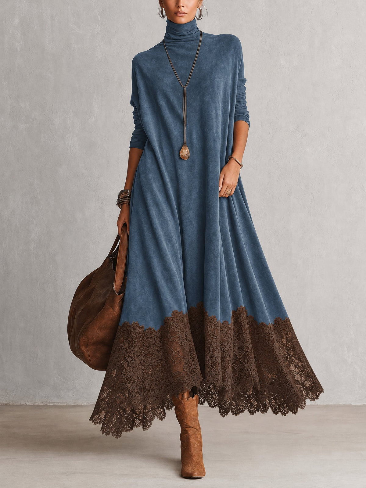 Front view of the dress in blue with a brown lace hem, worn with tan boots and tote 7