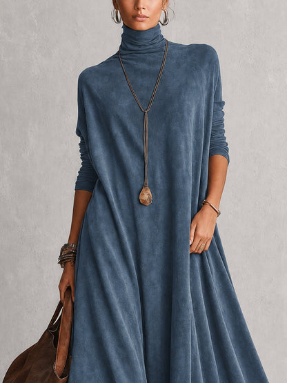 Close-up of the blue dress's turtleneck, long sleeves and draped bodice with a pendant necklace 11