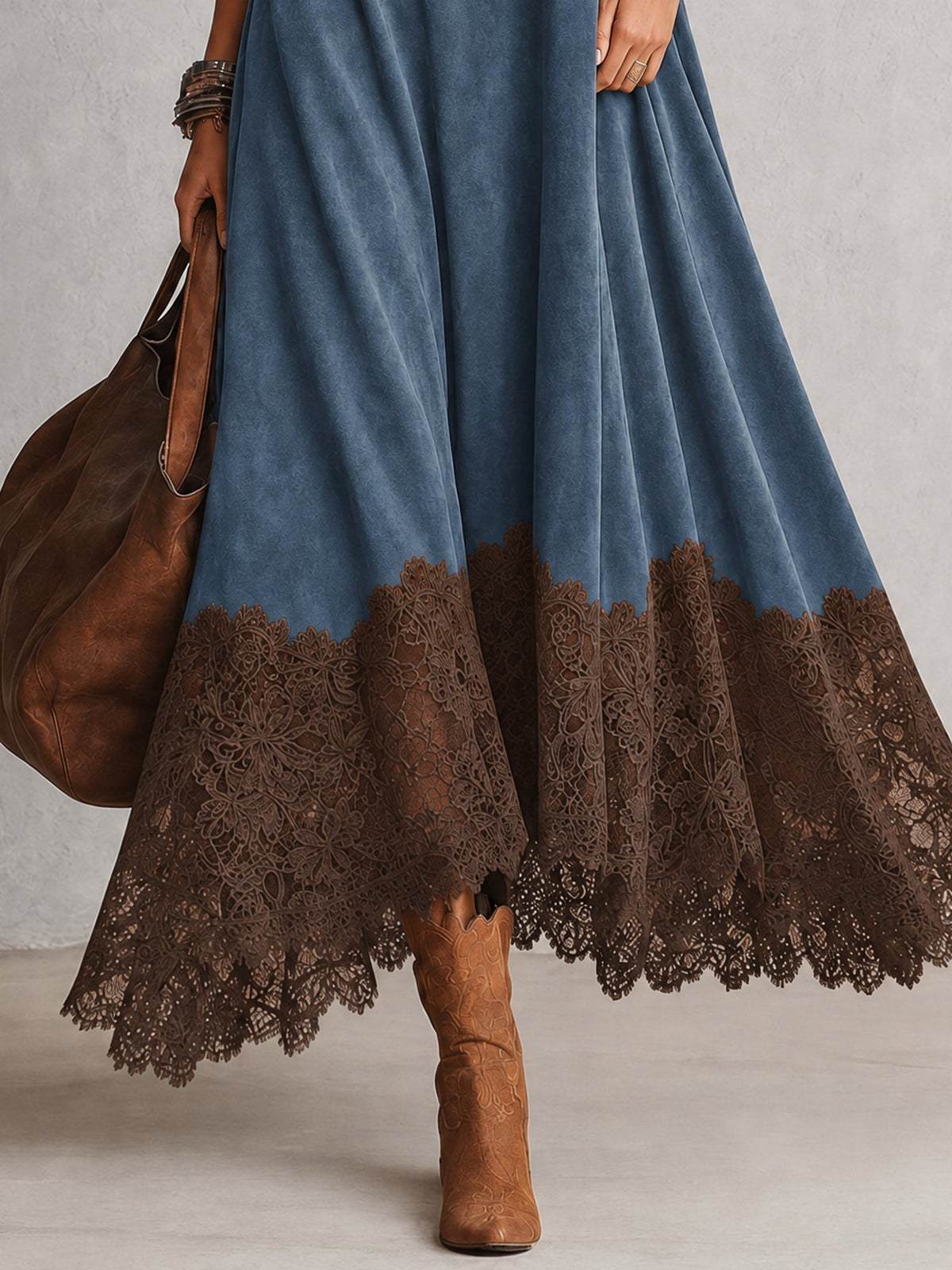 Close-up of the brown scalloped lace hem on the blue dress, with tan boots 12