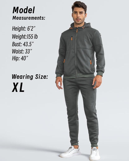 Model in the grey hoodie and joggers, standing full length beside a size and measurements panel 9