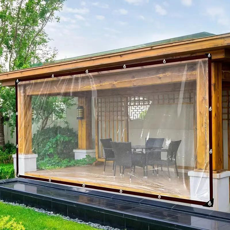 Clear tarp hung with eyelets across the open front of a wooden garden pavilion, sheltering a table and chairs. 3