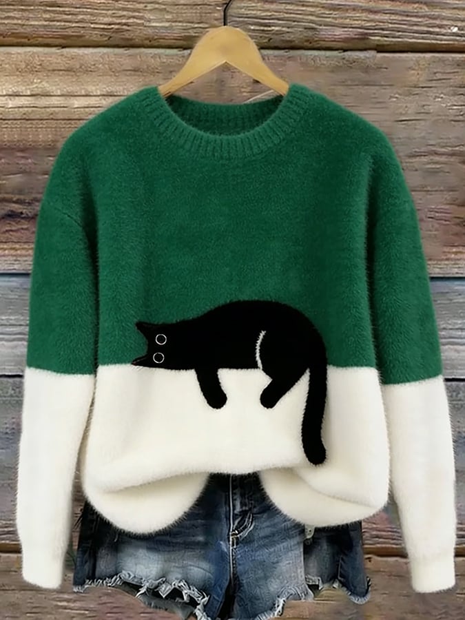 Fluffy jumper with green upper half, white lower half and black cat patch, on a hanger 4