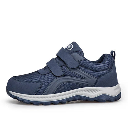 Navy shoe in side profile on a white background, showing both straps, grey midsole and tread 13