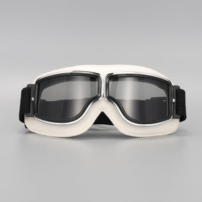 Front view of the cream-white padded goggles with chrome trim and smoky grey tinted lenses. 14