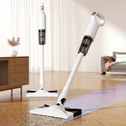 Two white stick vacuums standing on a wooden living room floor, one leaving a clean glowing strip through scattered crumbs. 1