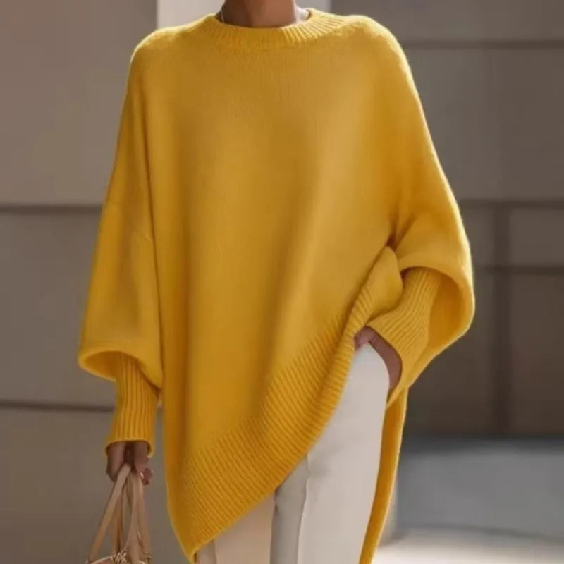 Yellow jumper with wide sleeves and ribbed cuffs, styled with white trousers and a beige handbag 6