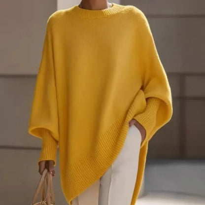 Yellow jumper with wide sleeves and ribbed cuffs, styled with white trousers and a beige handbag 6
