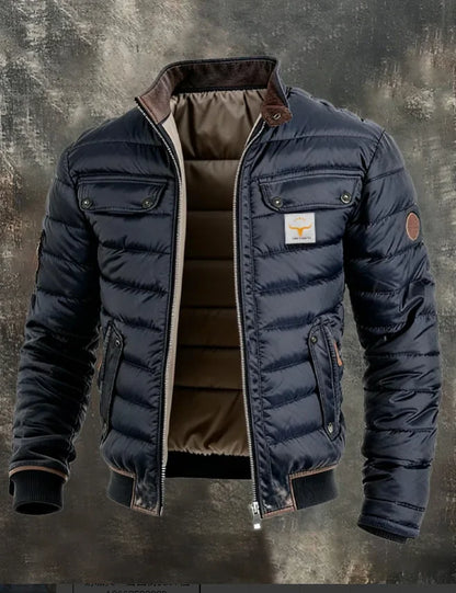 Navy quilted jacket slightly angled, open at the front, showing stand collar, pockets and sleeve patch 6