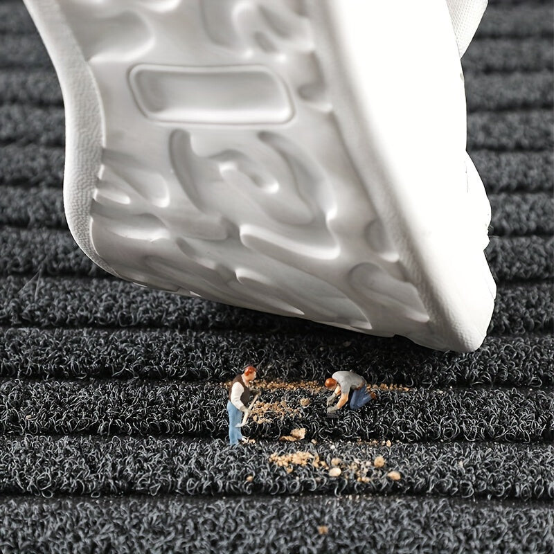 A white trainer sole hovers over the grey pile while tiny figures sweep up crumbs of dirt trapped in it. 4