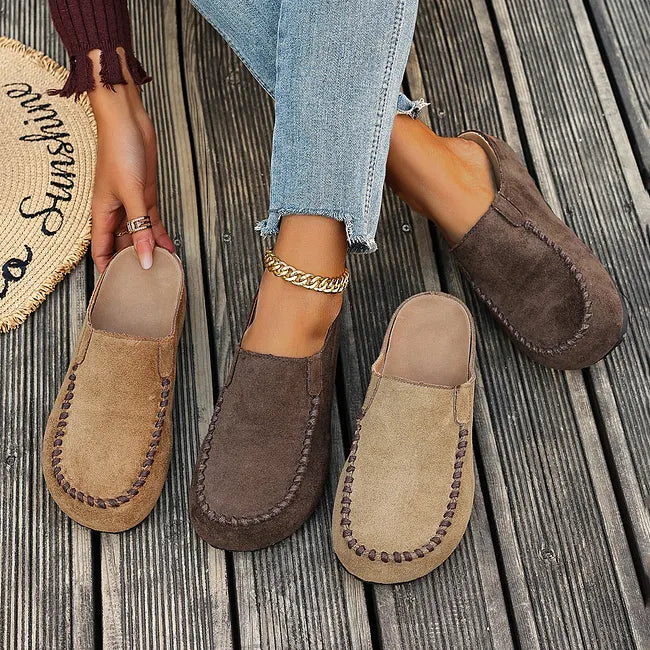 Both colours side by side: two tan and two dark brown slip-on mules, one pair of each laid out and one pair worn. 7