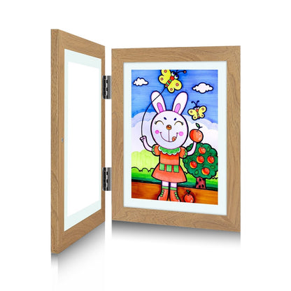 Oak-effect frame opened flat on its hinges, with a child's painting of a rabbit and butterflies displayed on the right. 3