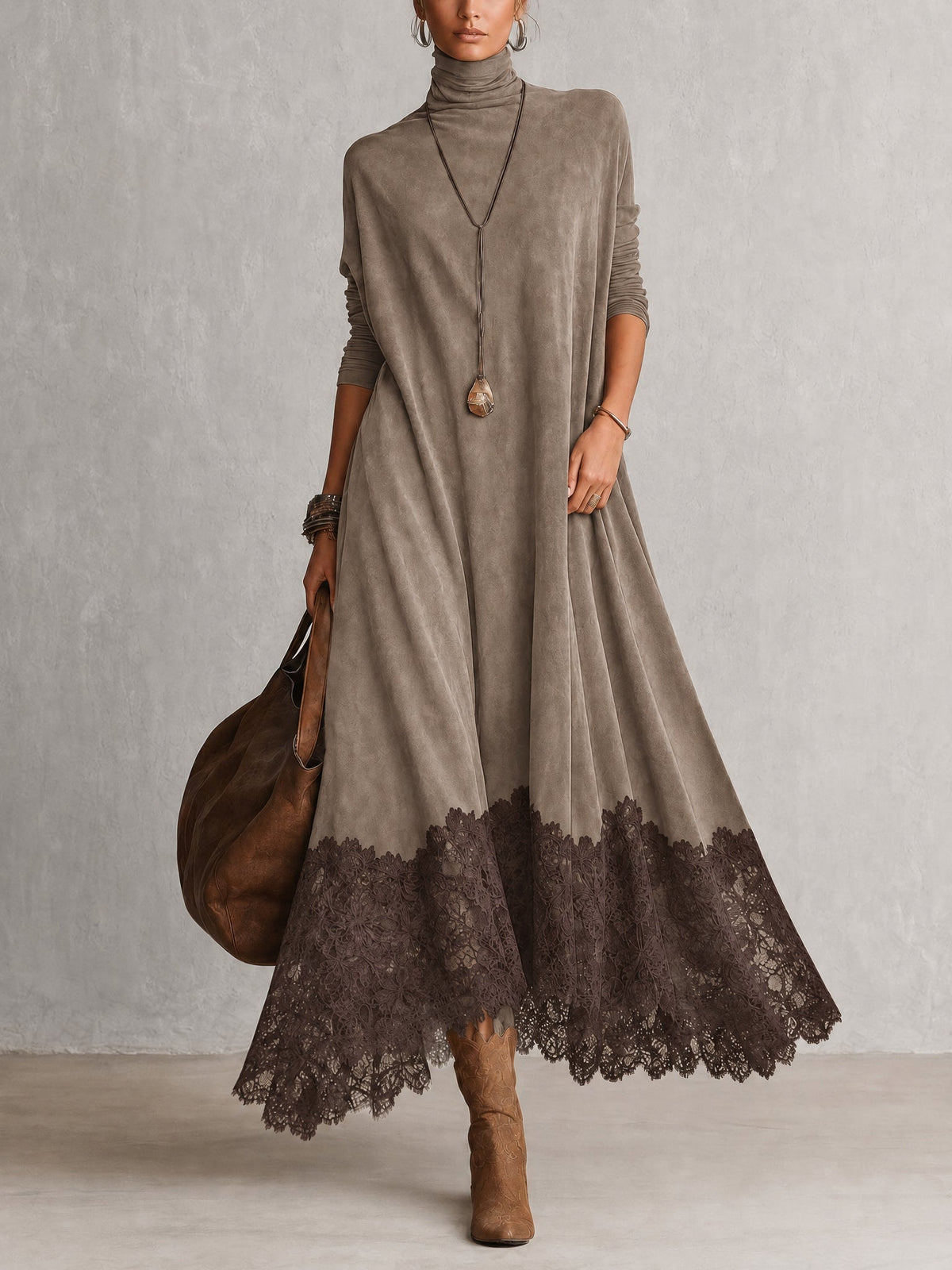 Front view of the dress in taupe with a darker brown lace hem, worn with boots 8