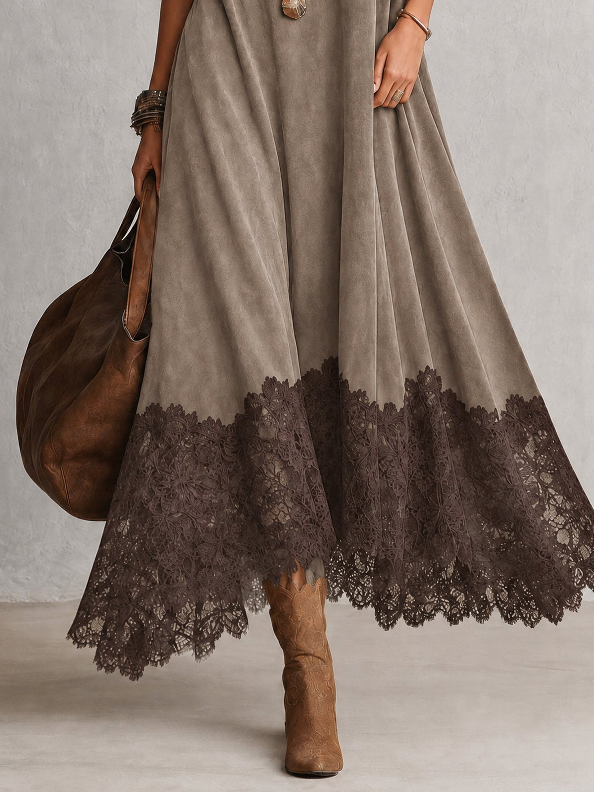 Detail of the taupe dress's flared skirt, with a darker brown lace border at the hem 14
