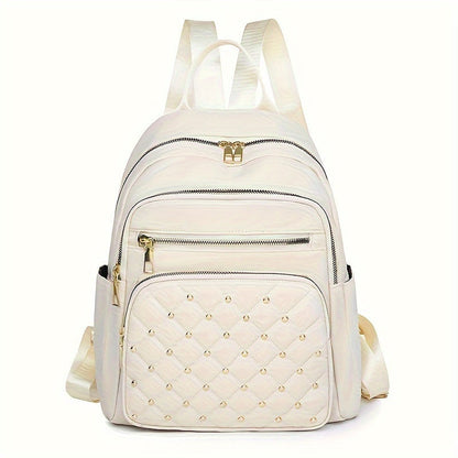 Cream backpack front view with a quilted, gold-studded front pocket and gold zip pulls 13