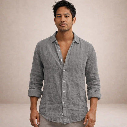 Model facing the camera in a grey linen shirt with a relaxed open collar and sleeves rolled to the forearms. 8