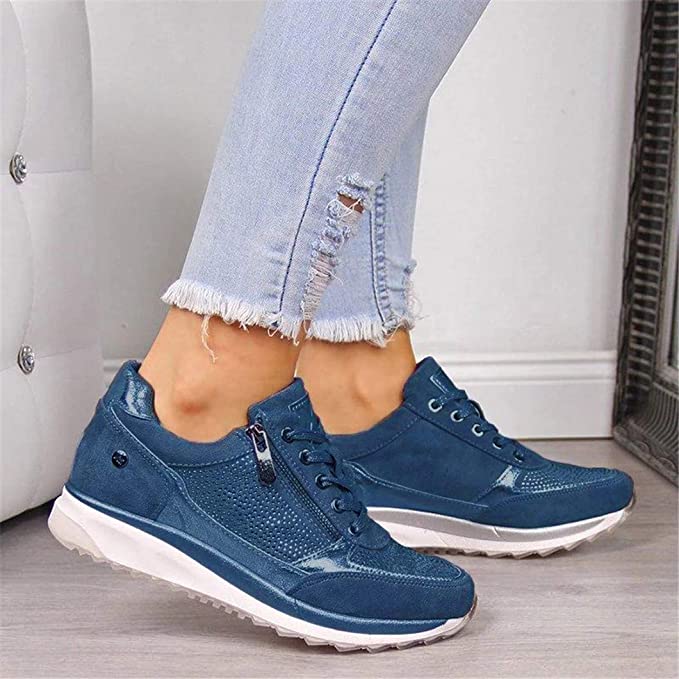 Blue version of the lace-up trainers with side zip and studded panel, shown on a model in ripped light-wash jeans. 3