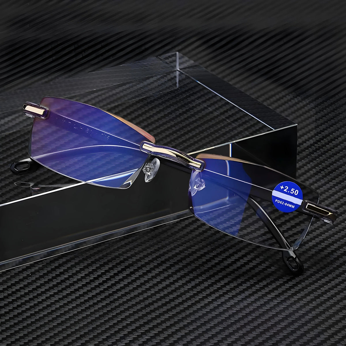 Rimless glasses with blue-tinted lenses and gold hinges propped against a clear block on a carbon-fibre style surface. 5