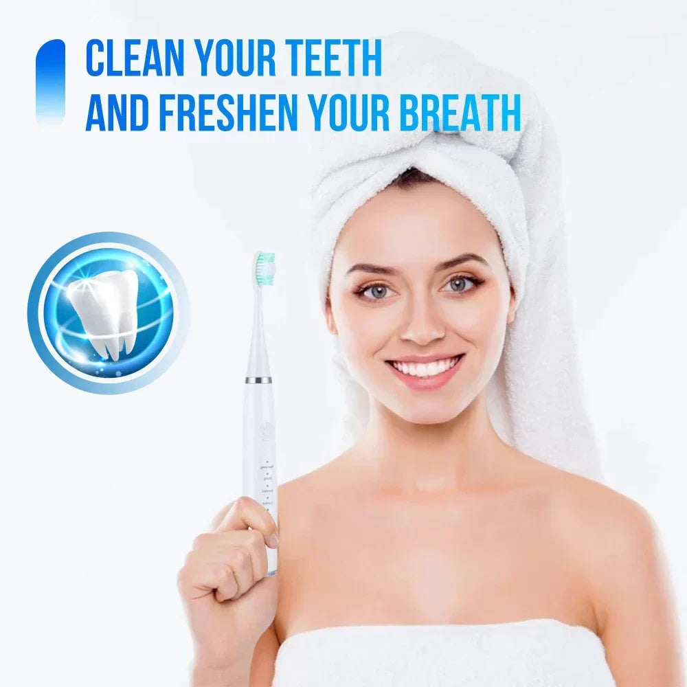 Second view of the woman in a hair towel holding the white electric toothbrush, with a tooth graphic and green-tipped brush head. 8