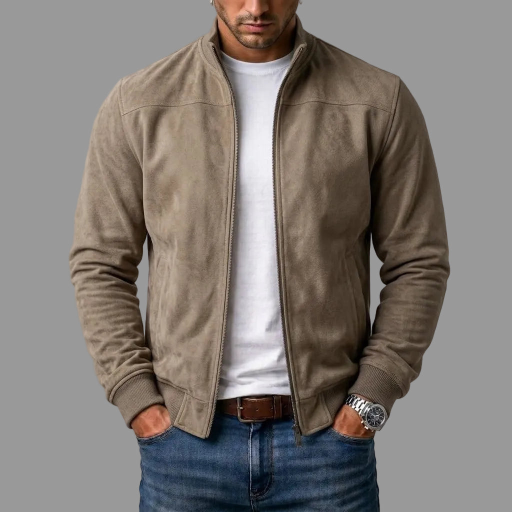 Model wearing the taupe suede-look bomber jacket open over a white t-shirt and jeans, hands in pockets, ribbed cuffs visible. 2
