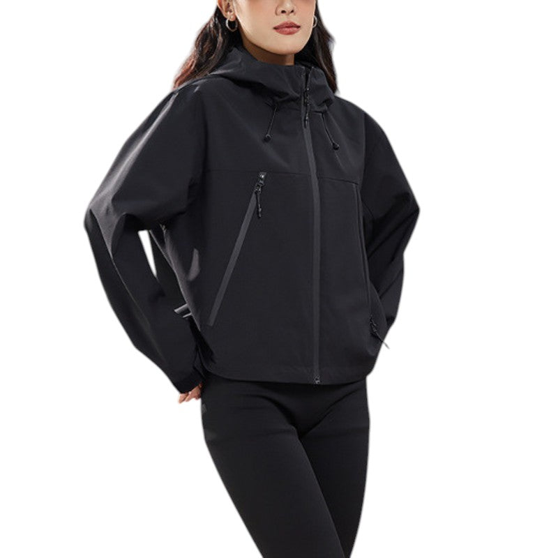 Close front view of the black jacket with the hood up and hand in pocket 17