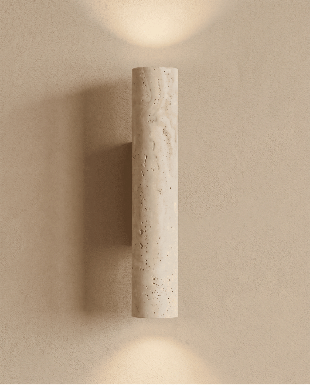 Front view of the lit travertine cylinder with light spreading above and below on the wall 7