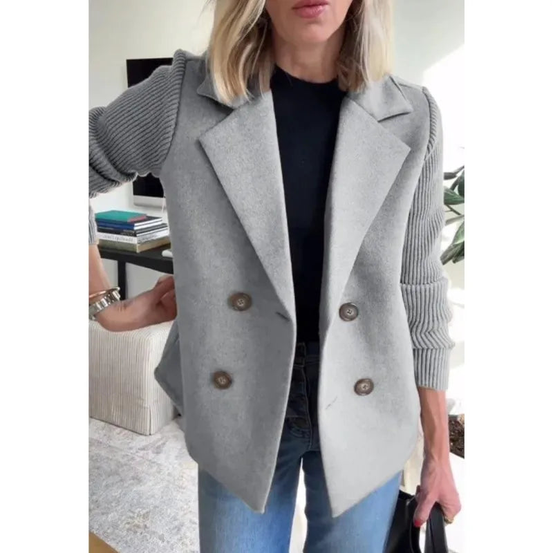 Light grey double-breasted jacket with ribbed sleeves, worn open over a black top and jeans 7