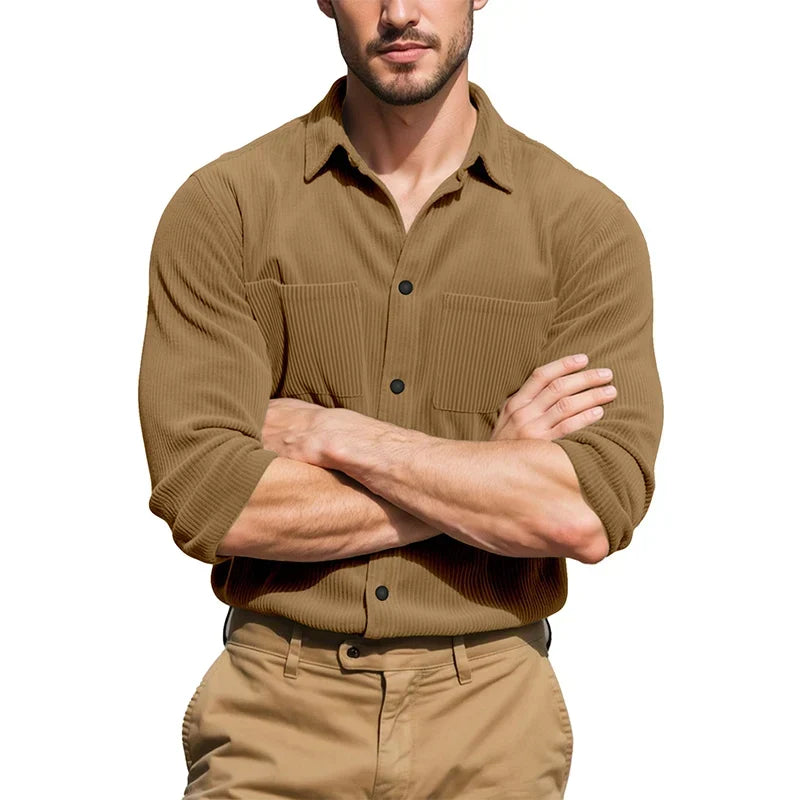 Model with arms crossed wearing the tan ribbed shirt with sleeves rolled, over khaki trousers 7